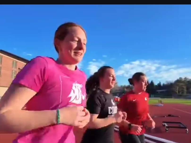 Sofiya Freimuth running with teammates on a track