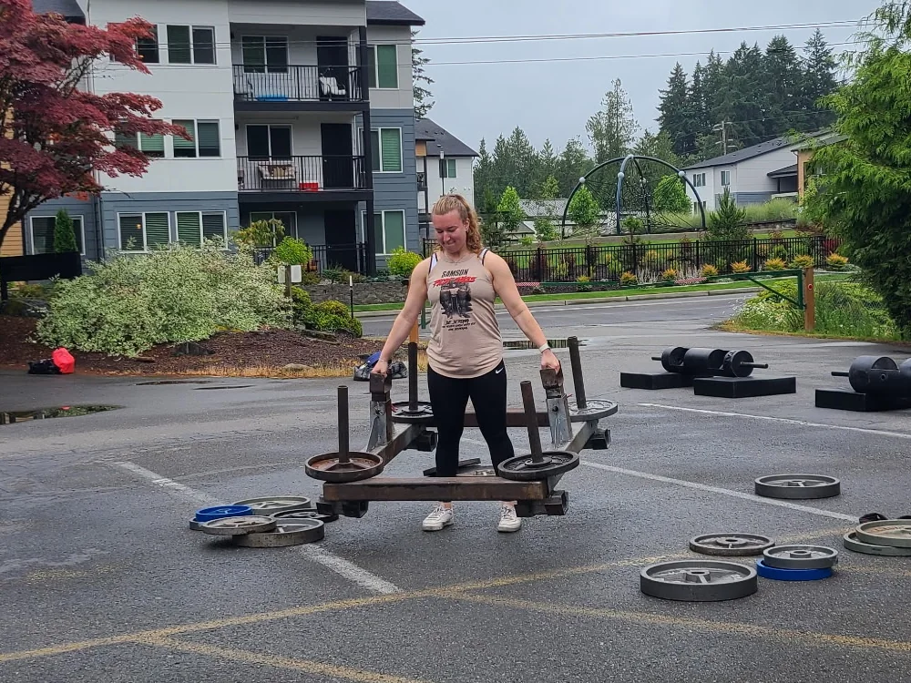 Sofiya Freimuth performing strength training with a loaded sled outdoors